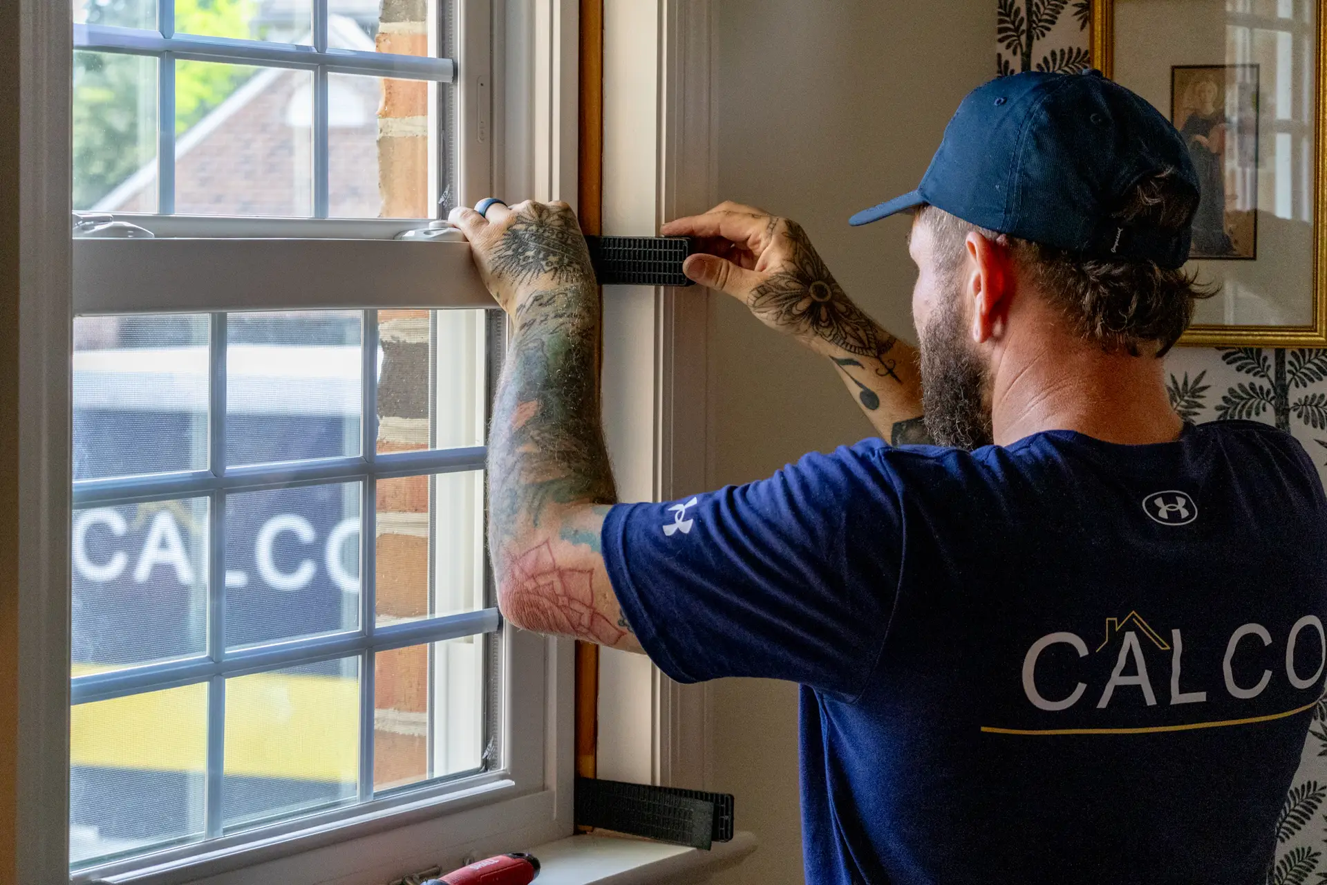 CalCo Employee Installing a New Window
