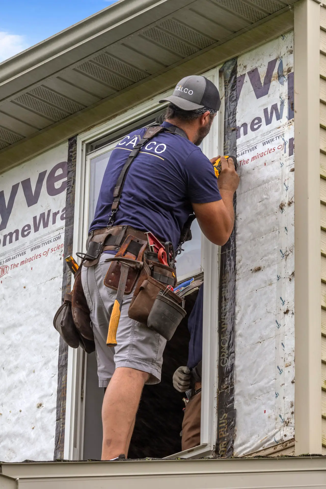CalCo installer securing flashing tape around a new window during a home renovation in Morgantown, Pennsylvania